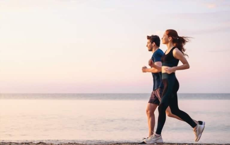 couple in running clothes by the beach